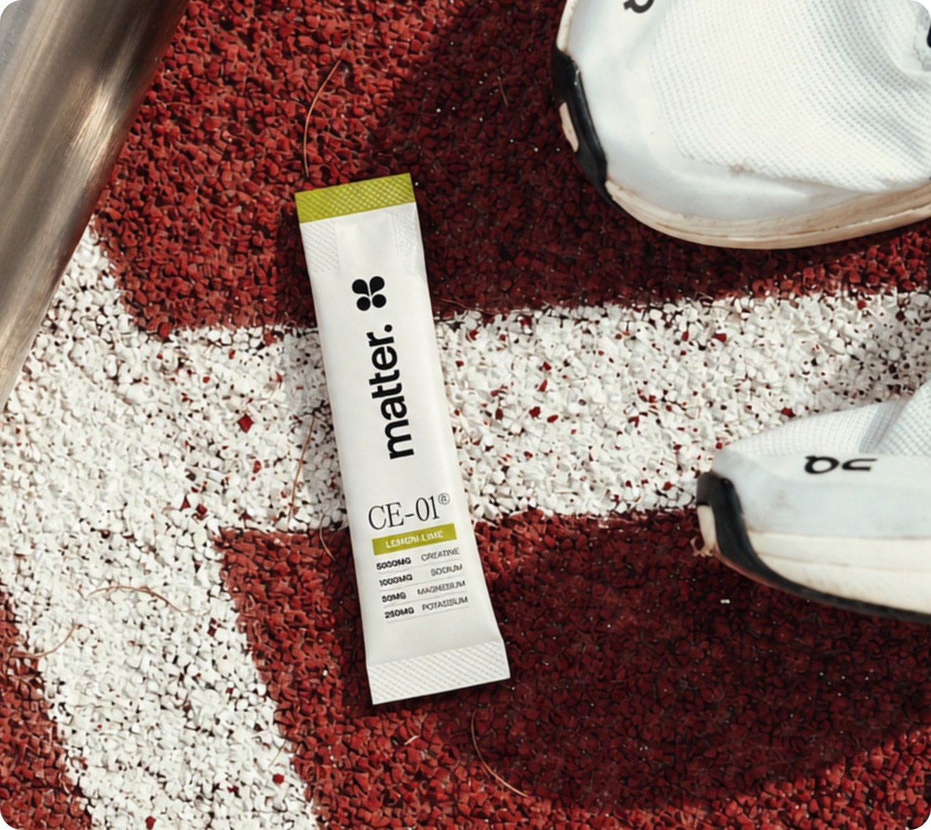 A CE-01 Lemon Lime sachet on a running track lane